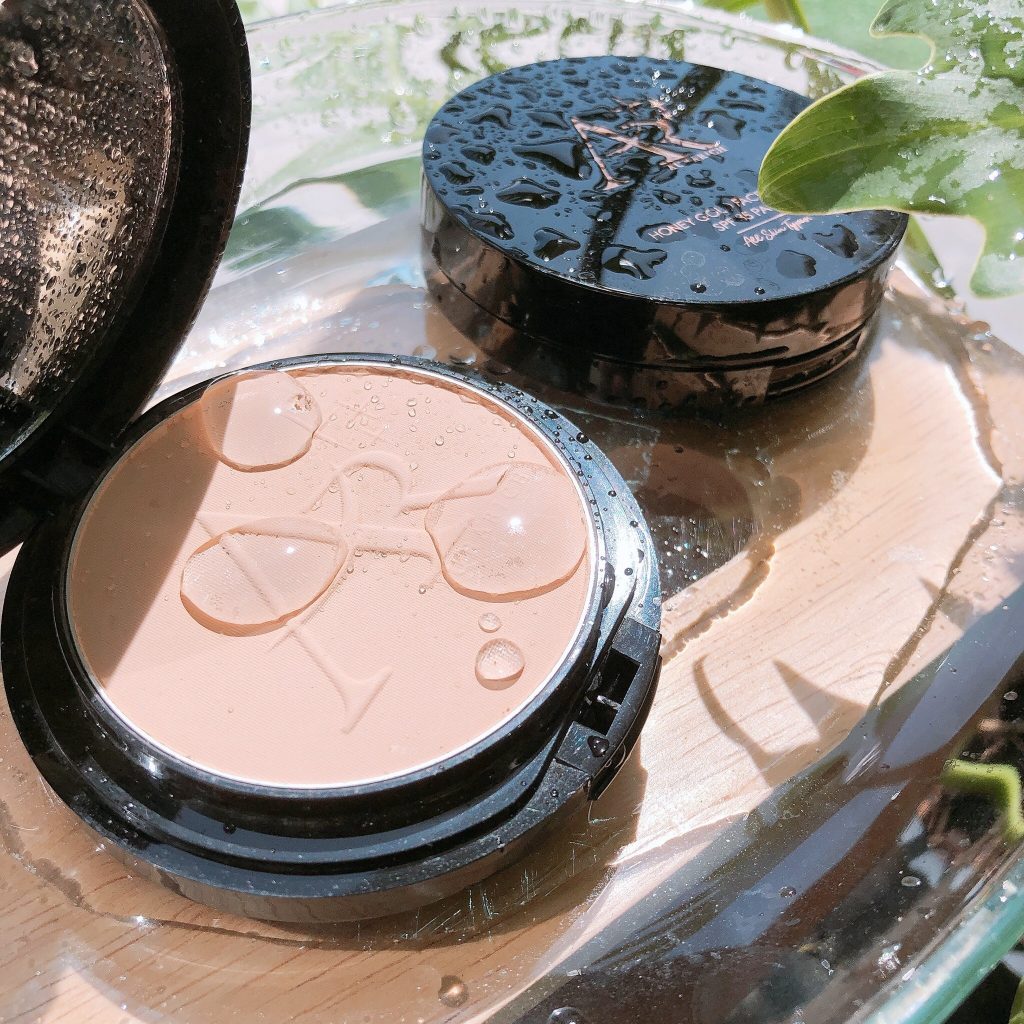 แป้งออร่าริช Honey Gold Face Powder SPF35 PA+++ เฉด 01 วางบนโต๊ะ ดูคุมมันสวย